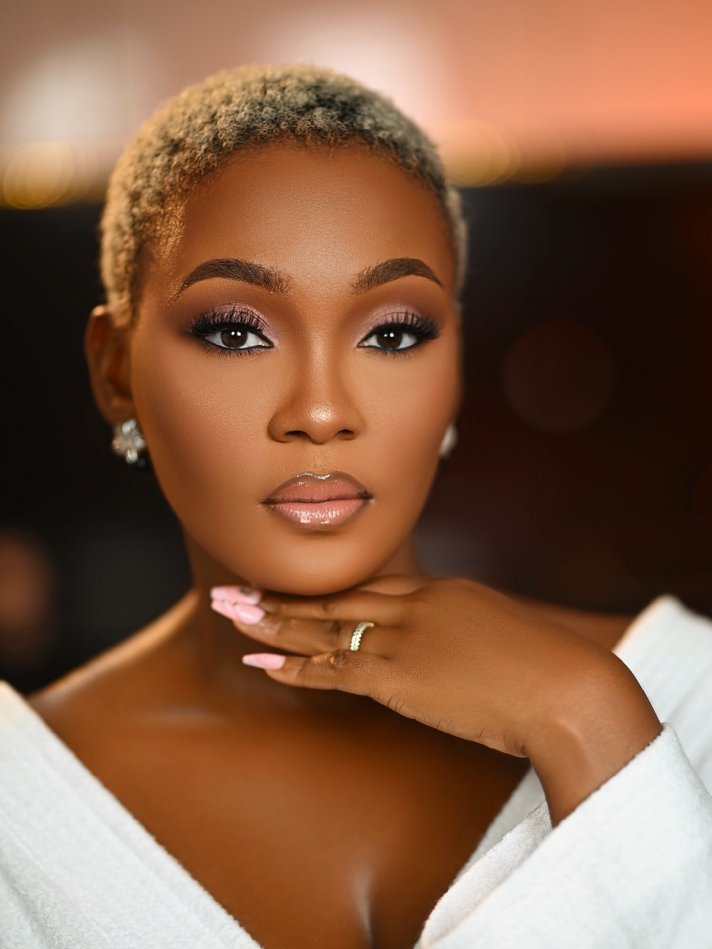 Bridal glam with soft pink eyes and a white robe